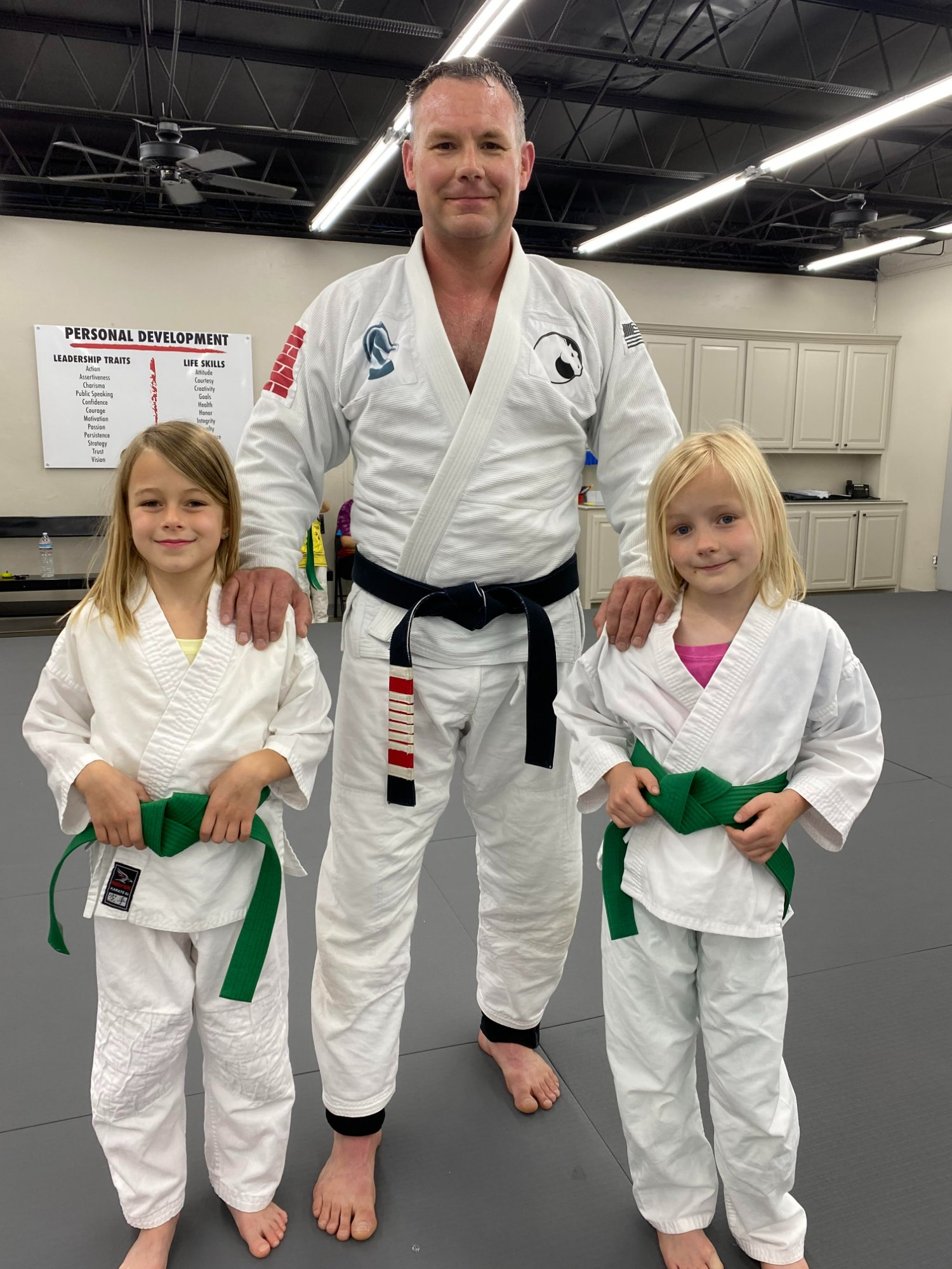 Professor Pittman with his two daughters in gi at Pittman Academy